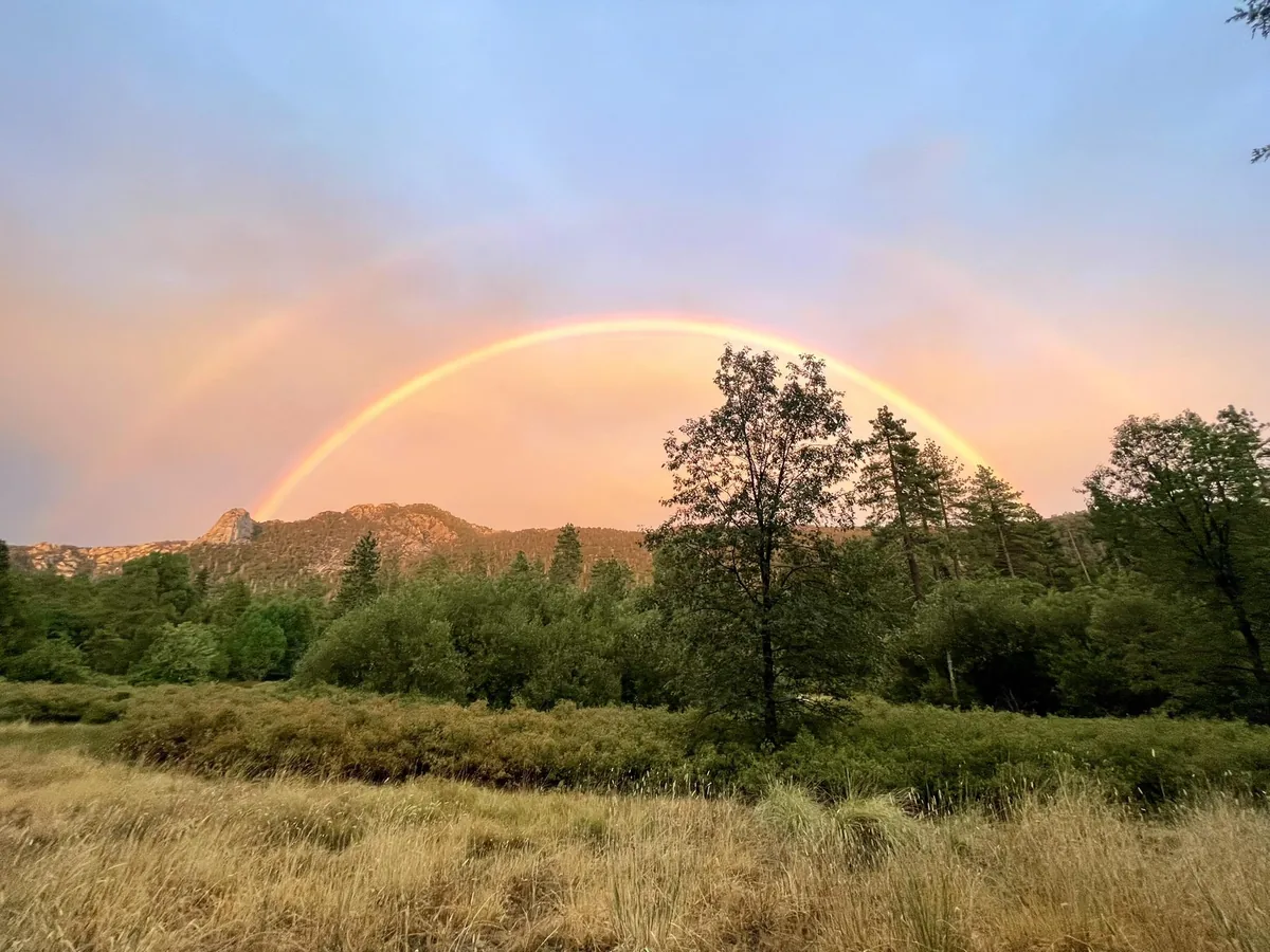 Double rainbow over the meadow below Tahquitz Peak at dusk